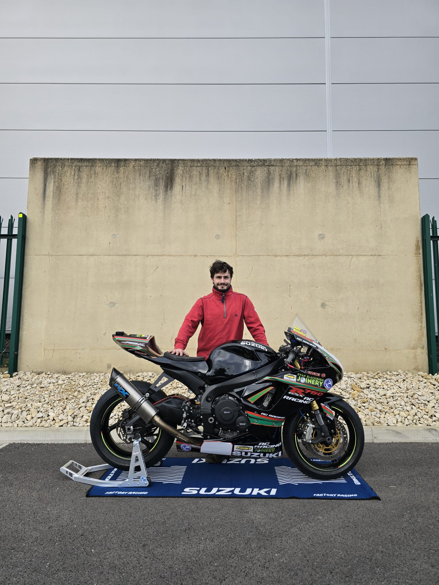 Owen posing with his Suzuki race bike